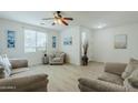 Bright living room featuring light flooring and comfy seating at 1792 W Loemann Dr, San Tan Valley, AZ 85144