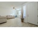 Living room with light walls, wood-look floors, and neutral furniture at 1792 W Loemann Dr, San Tan Valley, AZ 85144