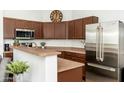 Modern kitchen with stainless steel appliances and wood cabinets at 22846 N 24Th St, Phoenix, AZ 85024