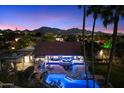 Stunning nighttime view of home, pool, and city lights at 24218 N 85Th St, Scottsdale, AZ 85255
