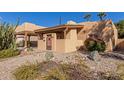 Tan stucco house with a covered entryway and drought-tolerant landscaping at 4620 E Montecito Ave, Phoenix, AZ 85018