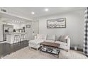 Living room features a sectional sofa, kitchen view, and cozy rug at 540 N May St # 1102, Mesa, AZ 85201
