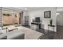 Open living area with sectional sofa, flat-screen TV, and backyard access at 540 N May St # 1102, Mesa, AZ 85201