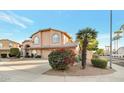 Two-story house with beige exterior, three-car garage, and palm tree at 6901 E Evans Dr, Scottsdale, AZ 85254