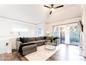 Spacious living area with hardwood floors, sectional sofa, and large window at 7272 E Gainey Ranch Rd # 75, Scottsdale, AZ 85258