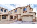 Tan two-story home with attached garage and front yard at 125 N 22Nd Pl # 30, Mesa, AZ 85213