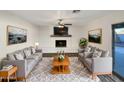 Bright living room featuring a fireplace and wood-look floors at 610 W Medina Ave, Mesa, AZ 85210
