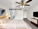 Spacious main bedroom with ensuite bathroom and barn door at 610 W Medina Ave, Mesa, AZ 85210