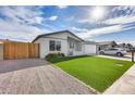 House exterior with artificial turf, gravel driveway and wood fence at 121 N Kachina --, Mesa, AZ 85203