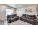 Living room with two reclining sofas and a patterned rug at 121 N Kachina --, Mesa, AZ 85203