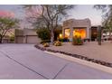 Stunning desert home with a large front yard, curved driveway, and beautiful landscaping at 15868 E Ponderosa Dr, Fountain Hills, AZ 85268