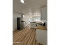 Remodeled kitchen with stainless steel appliances and wood-look flooring at 201 S Greenfield Rd # 333, Mesa, AZ 85206