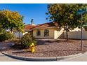 House exterior showcasing a front yard with trees and a fire hydrant at 3315 E Hampton Ave, Mesa, AZ 85204