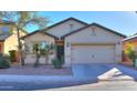 Front view of a single-story house with a two-car garage at 41331 W Lucera Ln, Maricopa, AZ 85138