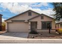 Single story home with a two car garage and desert landscaping at 931 W Cedar Tree Dr, San Tan Valley, AZ 85143