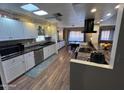 Bright kitchen featuring white cabinets, granite countertops, and a breakfast bar at 11411 N 91St Ave # 29, Peoria, AZ 85345