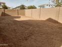 Large, unlandscaped backyard with block wall fencing at 21018 E Calle Luna Ct, Queen Creek, AZ 85142