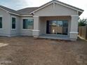 New construction home with a covered patio and unlandscaped backyard at 21018 E Calle Luna Ct, Queen Creek, AZ 85142