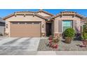 Tan house with a two-car garage and nicely landscaped front yard at 2232 W Park St, Phoenix, AZ 85041