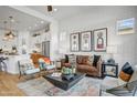 Bright and airy living room featuring a leather sofa and an exposed brick wall at 26032 S 229Th Pl, Queen Creek, AZ 85142
