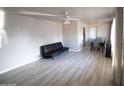 Living room features light wood floors, a couch and dining area at 3418 W Roma Ave, Phoenix, AZ 85017