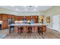 Gourmet kitchen featuring a large island, granite countertops, and stainless steel appliances at 4633 N 127Th Dr, Litchfield Park, AZ 85340