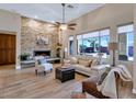 Spacious living area with a stone fireplace, large windows, and comfortable seating at 4633 N 127Th Dr, Litchfield Park, AZ 85340