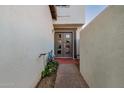 Front entryway with a gray double door, concrete path, and some greenery at 939 W Mission Ln, Phoenix, AZ 85021