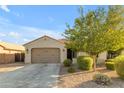 Single-story house with a two-car garage and mature trees at 2008 E Stacey Rd, Gilbert, AZ 85298