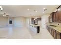 Modern kitchen with granite countertops and dark wood cabinets at 20856 E Arroyo Verde Dr, Queen Creek, AZ 85142