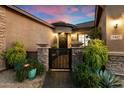 Charming courtyard entry with a decorative wrought iron gate at 2317 W Horsetail Trl, Phoenix, AZ 85085