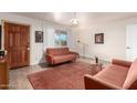 Living room with two orange couches and wood floors at 2325 W Orchid Ln, Phoenix, AZ 85021