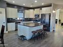 Modern kitchen with island, stainless steel appliances, and ample cabinetry at 28677 N Roselite Ln, San Tan Valley, AZ 85143