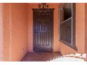 Dark brown front door with decorative hardware at 3020 E Des Moines St, Mesa, AZ 85213