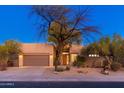 Single-story home with desert landscaping, two-car garage, and inviting entryway at 32427 N 71St Way, Scottsdale, AZ 85266