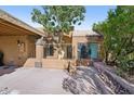 Tan stucco exterior with covered carport and desert landscaping at 5138 E Holly St, Phoenix, AZ 85008