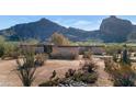 Mid-century modern home with brick exterior, desert landscaping, and mountain views at 6105 N Camelback Manor Dr, Paradise Valley, AZ 85253