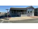 Single-story home with gray siding, covered porch, and rock landscaping at 7750 E Broadway Rd # 911, Mesa, AZ 85208
