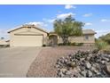 Tan house with a two-car garage and desert landscaping at 12411 N Fountain Hills Blvd, Fountain Hills, AZ 85268