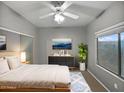 Cozy bedroom with ceiling fan, sliding mirror closet doors, and large window at 1351 N Pleasant Dr # 2079, Chandler, AZ 85225
