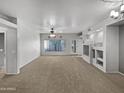 Spacious living room with plush carpet and built-in shelving at 1351 N Pleasant Dr # 2079, Chandler, AZ 85225