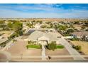 Aerial view of a single-story home with a pond, landscaping, and a three-car garage at 21406 E Mewes N Rd, Queen Creek, AZ 85142