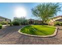 Lovely curb appeal! This home features a large grassy area and mature trees at 25410 N 46Th Ln, Phoenix, AZ 85083