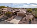 Elevated view of single-story home with tile roof, two-car garage, and desert landscaping at 5217 S Crested Saguaro Ln, Gold Canyon, AZ 85118