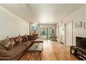 Living room features a comfortable sectional sofa, hardwood floors, and access to a patio at 8651 E Royal Palm Rd # 105, Scottsdale, AZ 85258