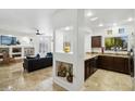 Open kitchen with dark wood cabinets and tile floors at 9100 E Raintree Dr # 130, Scottsdale, AZ 85260
