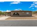 Front view of tan brick home with carport at 11020 N 13Th St, Phoenix, AZ 85020