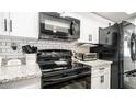 Granite countertops and black appliances in this updated kitchen at 14821 N 51St Dr, Glendale, AZ 85306