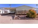 Single-wide manufactured home with carport and landscaped yard at 2229 N Higley Rd, Mesa, AZ 85215