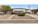 Mobile home with neat landscaping and a spacious driveway at 2650 W Union Hills Dr # 164, Phoenix, AZ 85027